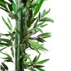 Planta de bambú artificial colocada en macetero de yeso